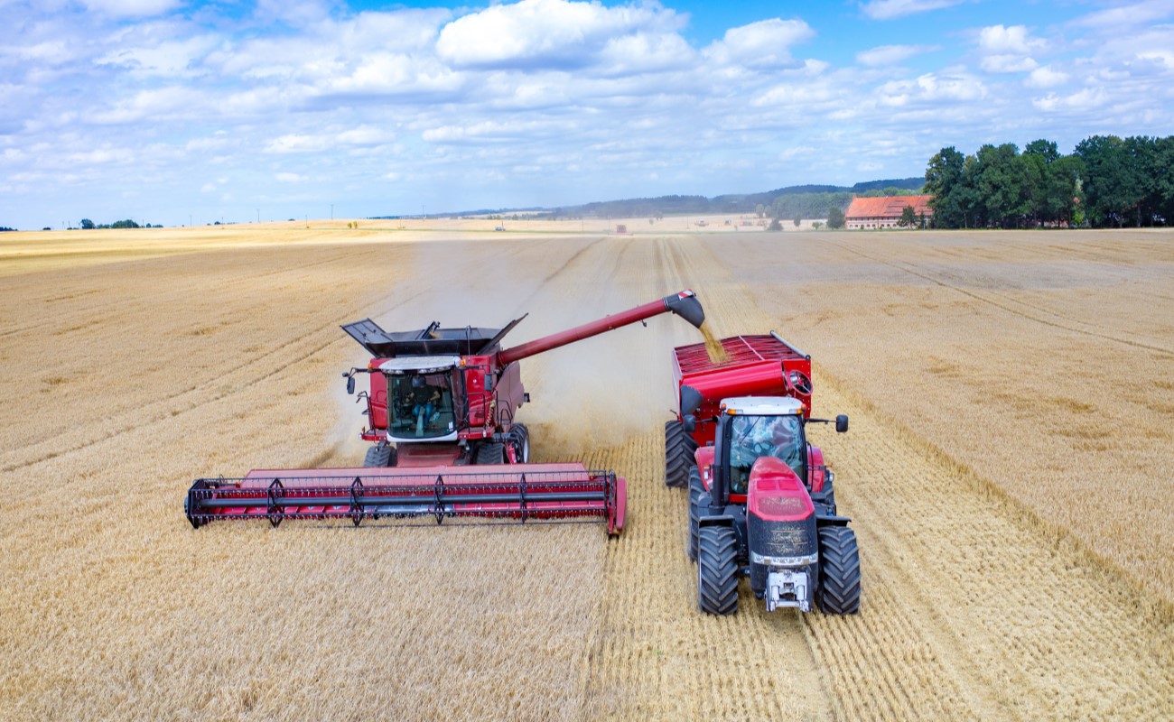 Combine and tractor in the field